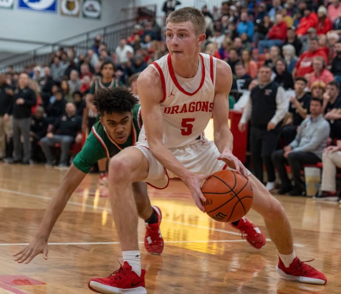 New Palestine High School's Ian Stephens (5) dribbles past a Lawrence North High School defender, at NPHS, Monday, Jan. 30, 2023, during a game won by LNHS, 59-58.